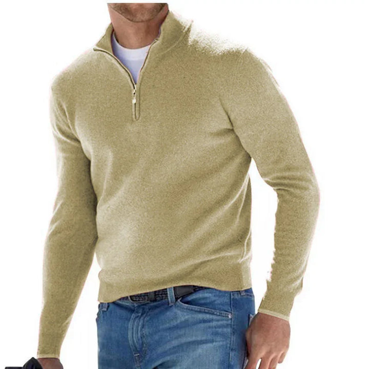 Men's beige quarter-zip sweater paired with blue jeans, casual winter outfit