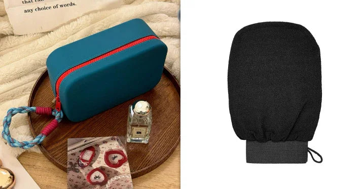Blue zippered cosmetic bag with red zipper and braided handle on wooden tray with perfume bottle and fabric on beige surface