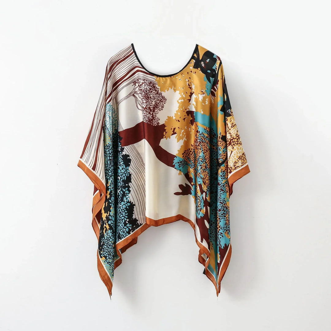 Flowy bohemian poncho top with autumn tree print in mustard, teal, and brown tones