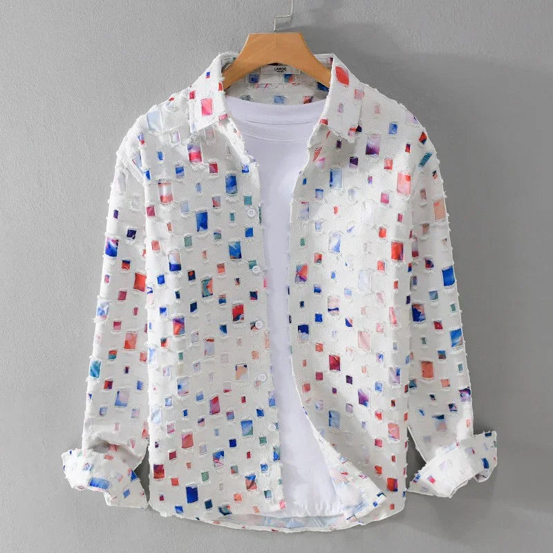 White button-up shirt with multicolor square patterns over a plain white t-shirt on wooden hanger