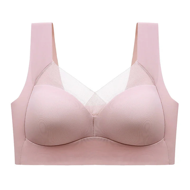 Seamless light pink bra with wide straps and sheer mesh panel, wireless lingerie