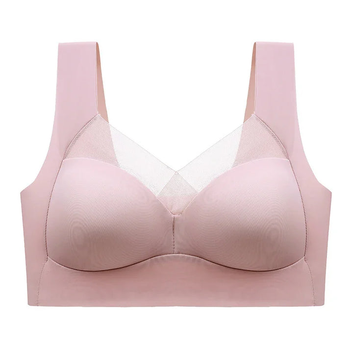 Seamless light pink bra with wide straps and sheer mesh panel, wireless lingerie