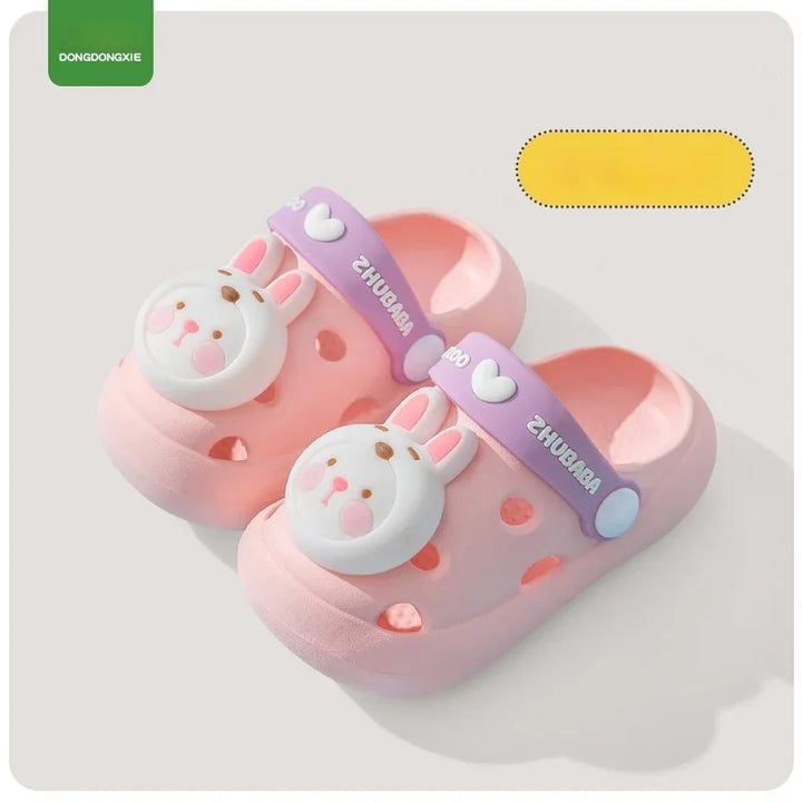 Pink kids clogs with bunny face decoration and purple straps reading ZHUBABA on white background