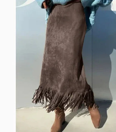 Brown suede fringe skirt paired with tan ankle boots and blue knit sweater