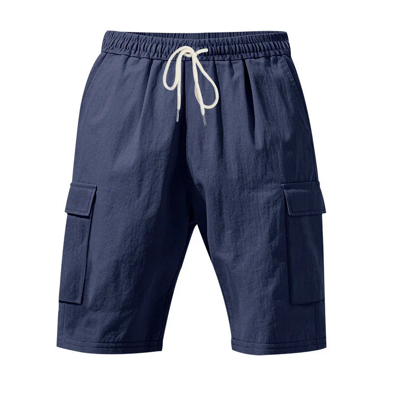 Navy blue men's cargo shorts with elastic waistband and white drawstring, side flap pockets