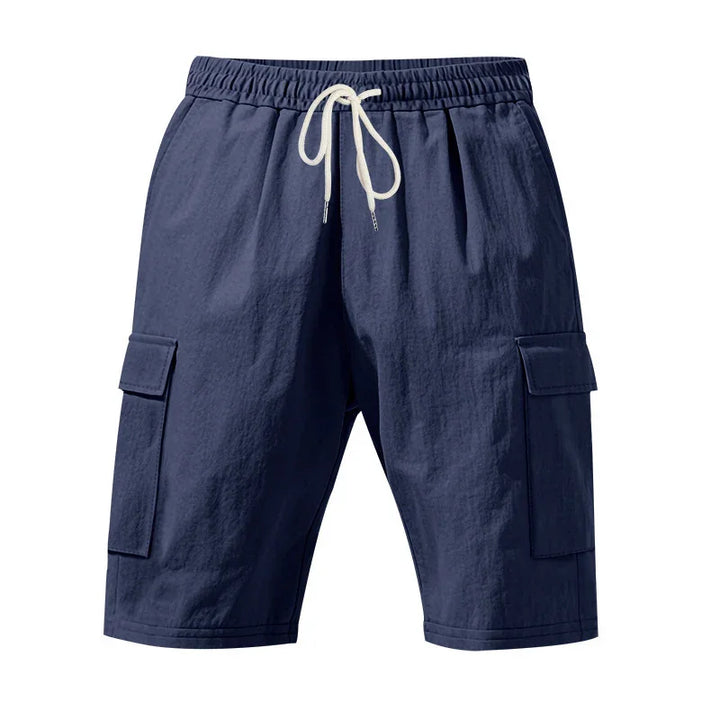Navy blue men's cargo shorts with elastic waistband and white drawstring, side flap pockets