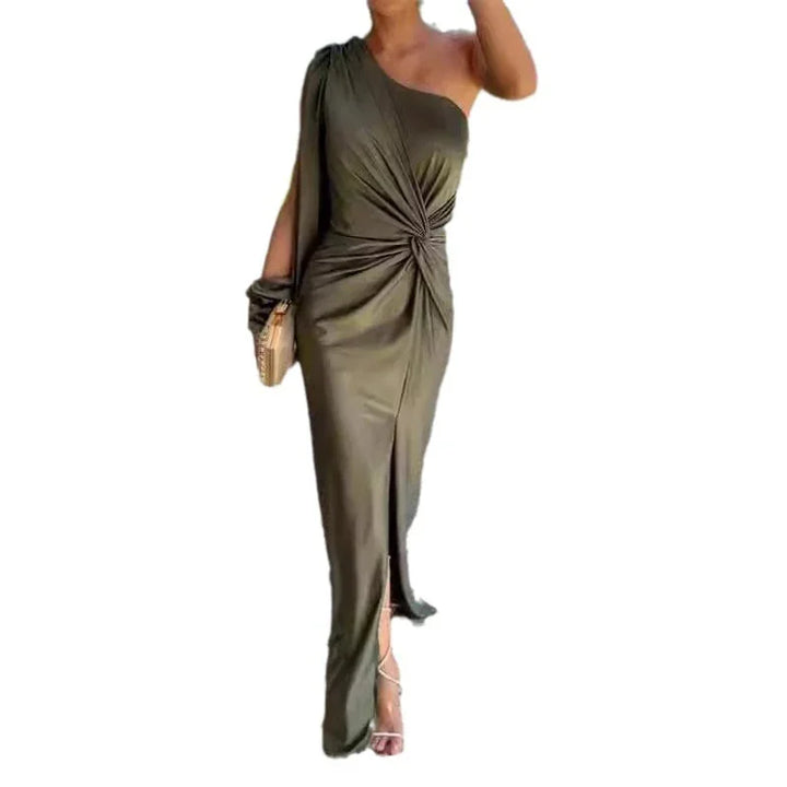 Woman wearing olive green one-shoulder ruched evening gown with front slit and holding clutch