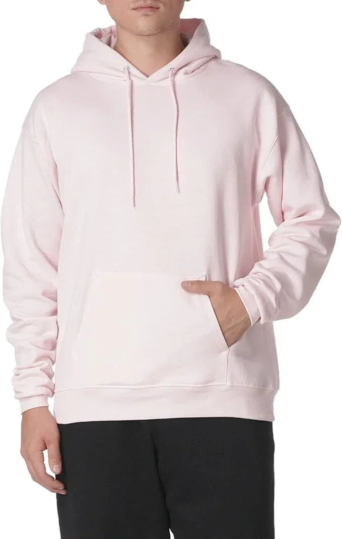 Man wearing light pink hoodie with front pocket and drawstrings, paired with black pants