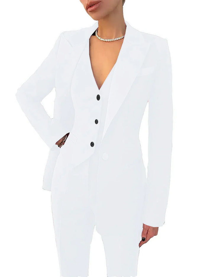 Woman wearing a white fitted blazer with three black buttons and a pearl necklace