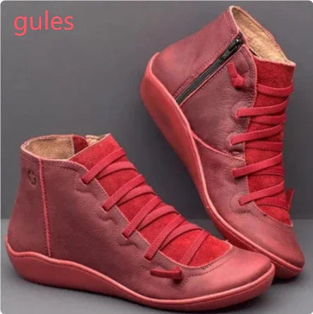 Red leather high-top sneakers with side zipper and matching red laces on dark background
