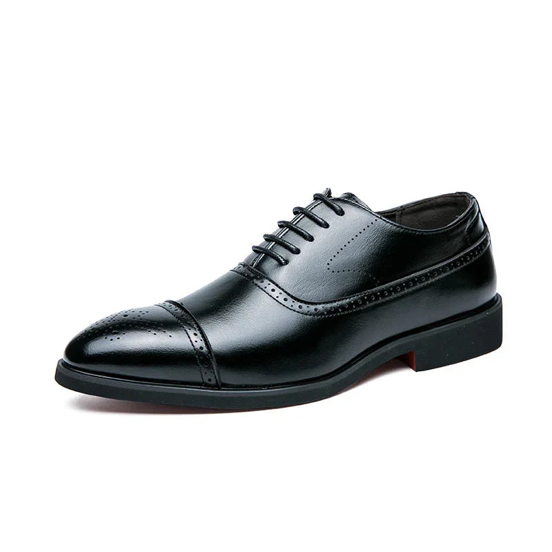 Black leather men's dress shoe with brogue detailing and laces on white background
