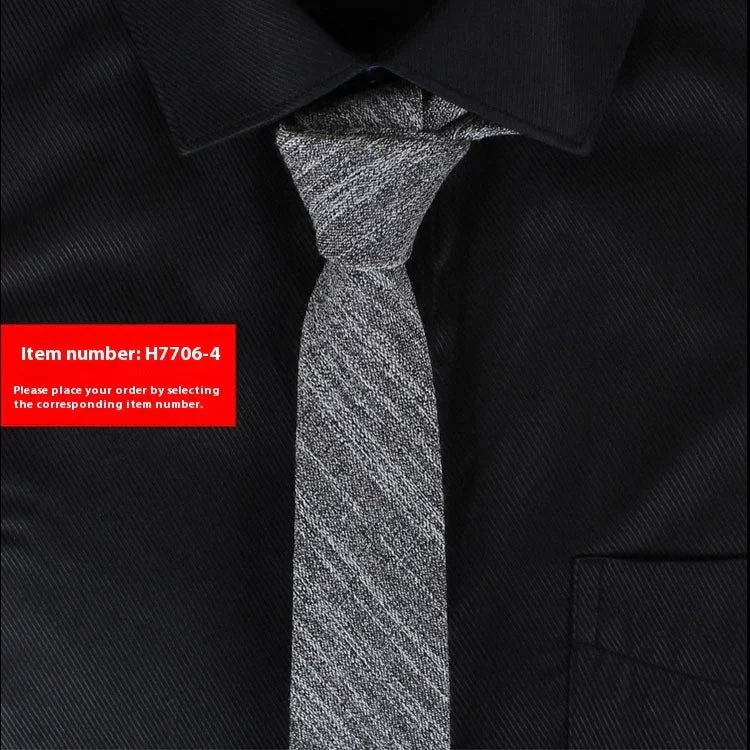 Silver textured necktie on black collared shirt with item number H7706-4 label