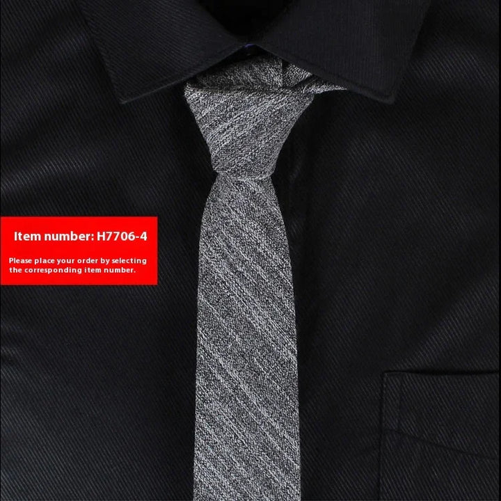 Silver textured necktie on black collared shirt with item number H7706-4 label