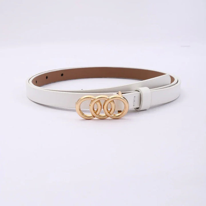 White leather belt with triple gold circular buckle, fashion accessory on plain background