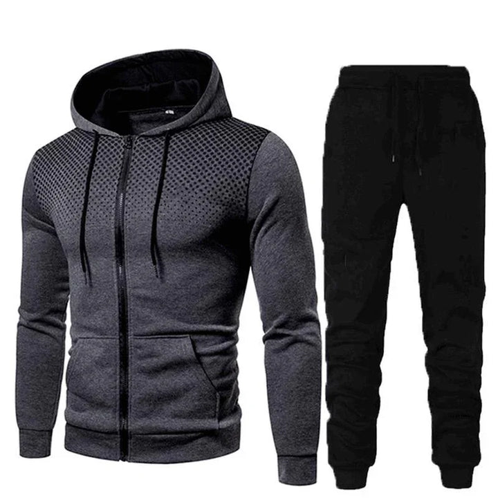 Men's athletic two-piece outfit with dark gray zip-up hoodie featuring textured shoulders and black jogger pants