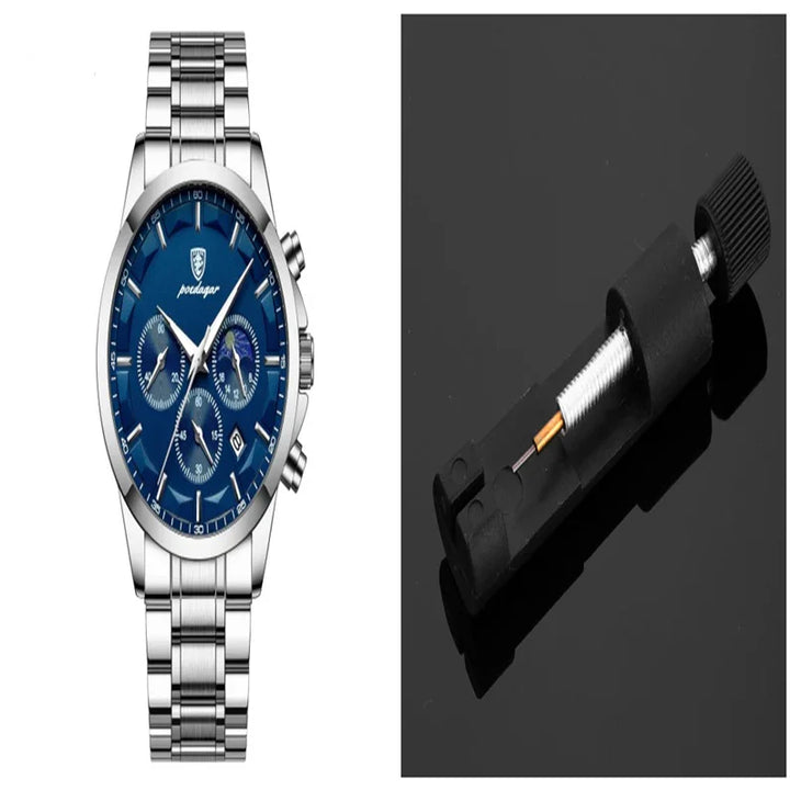 Silver stainless steel wristwatch with blue dial and chronograph next to black watch link remover tool