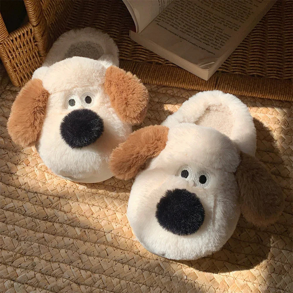 Pair of fluffy beige dog face slippers with brown ears and black noses on woven mat
