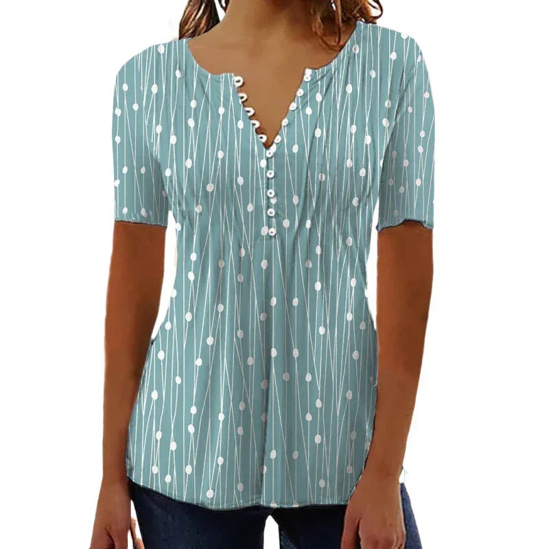 Woman wearing light blue short-sleeve blouse with white dot and line pattern, button-down front