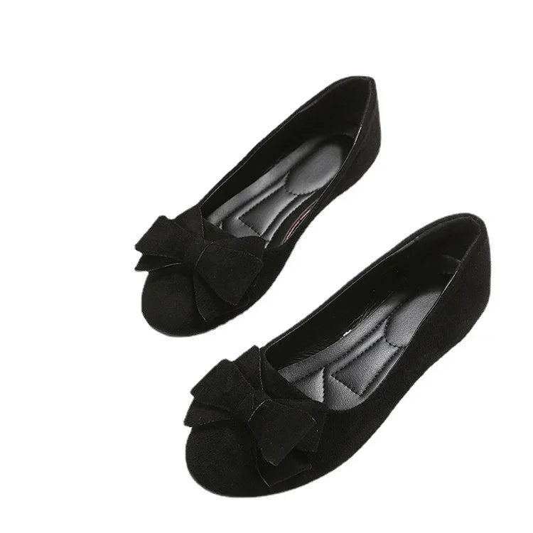 Black suede women’s ballet flats with large bow detail and cushioned insoles