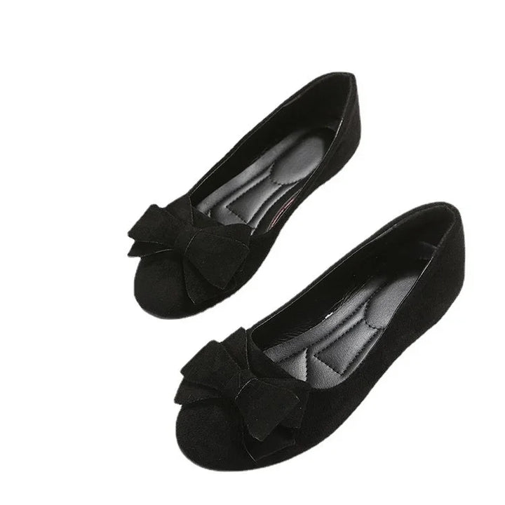 Black suede women’s ballet flats with large bow detail and cushioned insoles