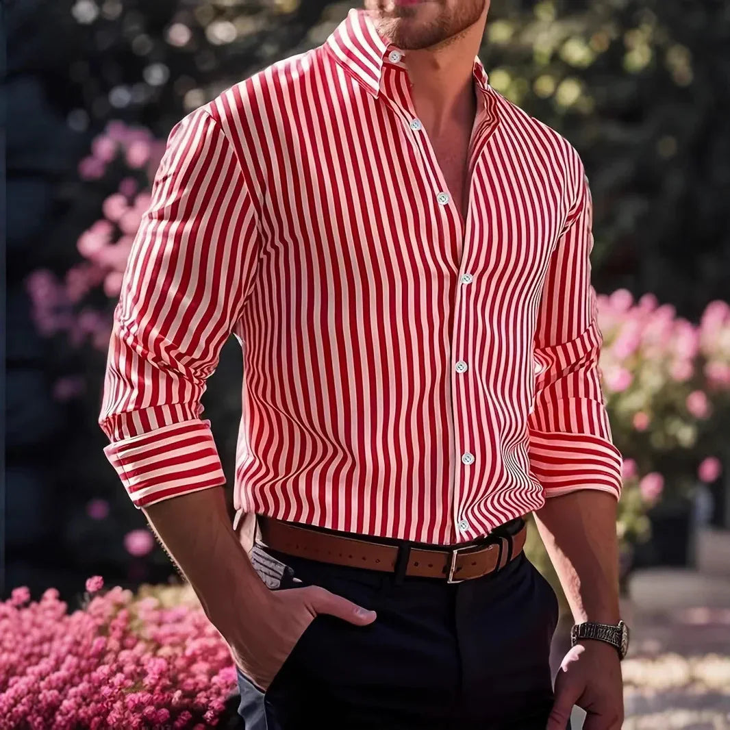 Man wearing red and white striped button-up shirt with rolled sleeves outdoors