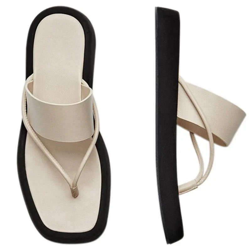 Beige cushioned thong sandals with thick black sole, modern minimalist design