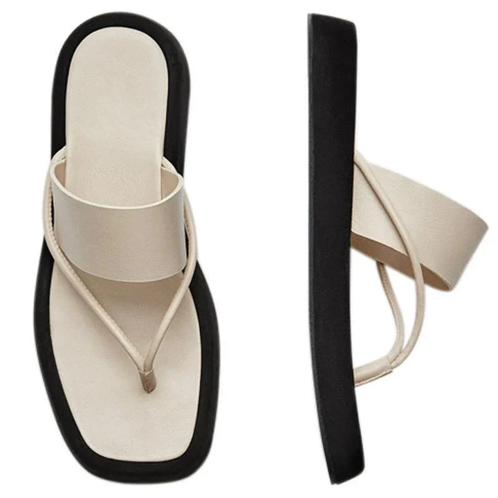 Beige cushioned thong sandals with thick black sole, modern minimalist design