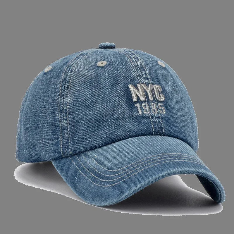 Blue denim baseball cap with embroidered text NYC 1985 on front panel
