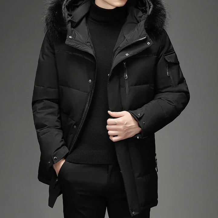 Man wearing a black padded winter jacket with fur-trimmed hood and black outfit
