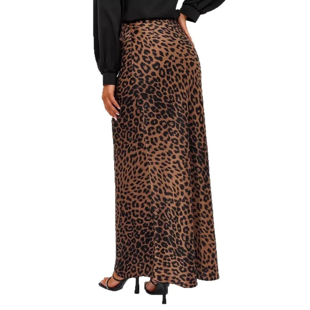 Woman wearing a brown and black leopard print long skirt paired with black blouse and black heeled sandals