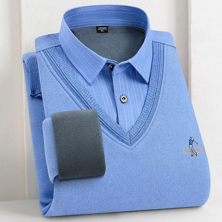 Folded blue V-neck sweater with a blue pinstripe dress shirt layered underneath on white background