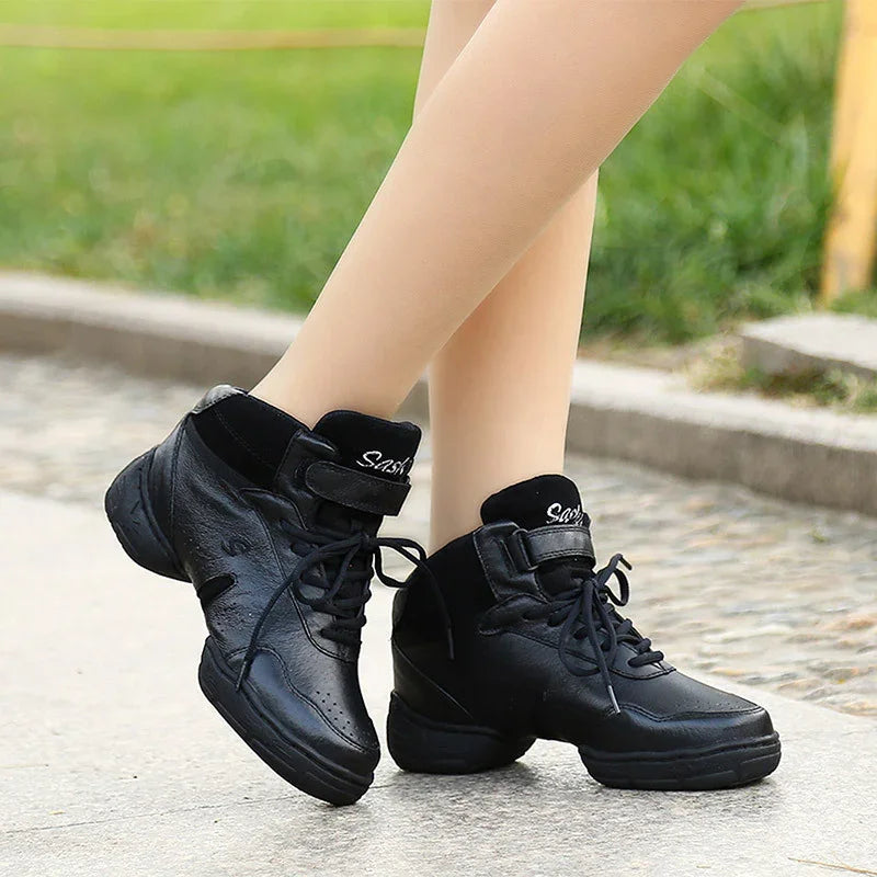 Black leather lace-up high-top dance sneakers worn outdoors on pavement