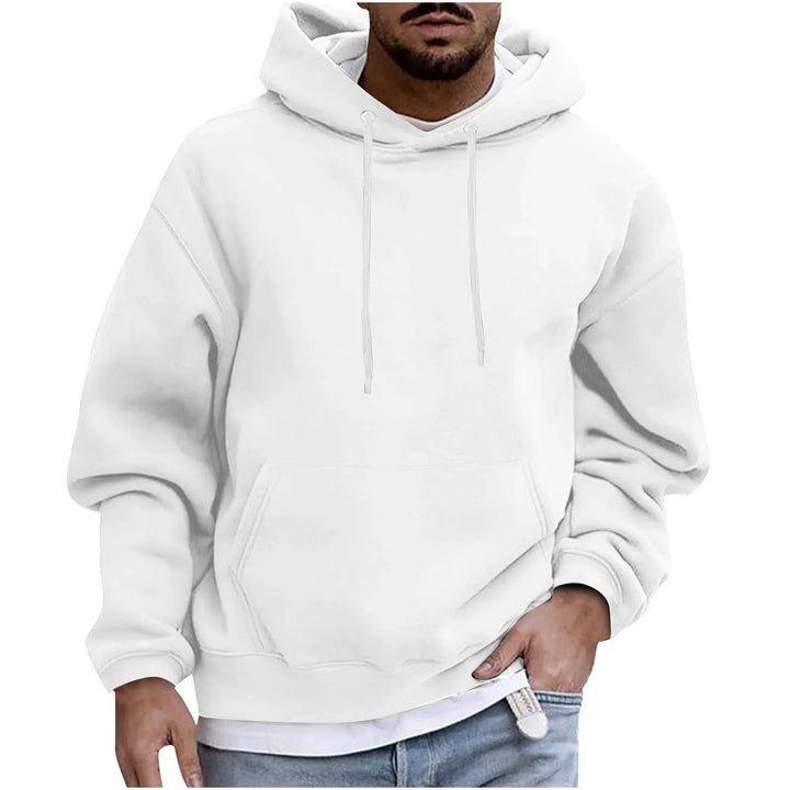 Man wearing plain white casual hoodie with front pocket and drawstrings, paired with blue jeans