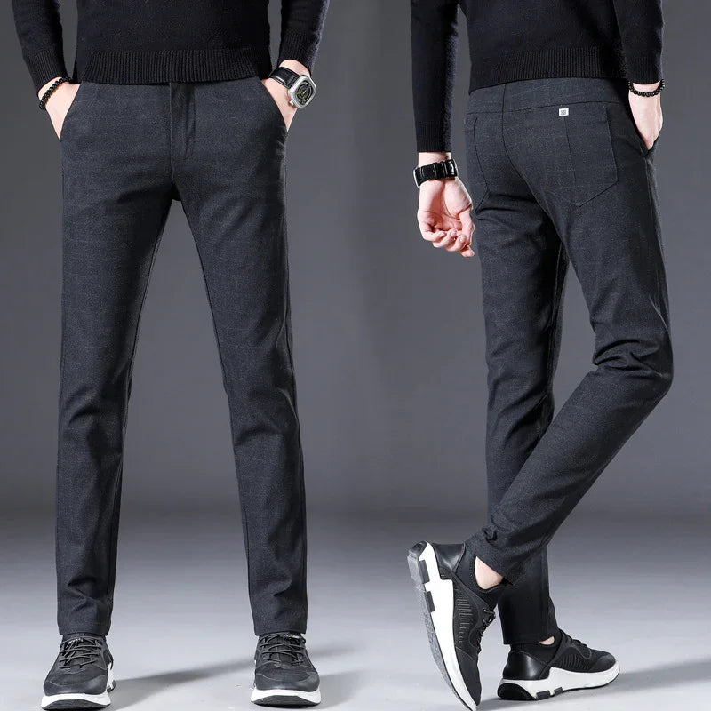 Men's black slim fit trousers paired with black sneakers and black knit sweater, front and back view
