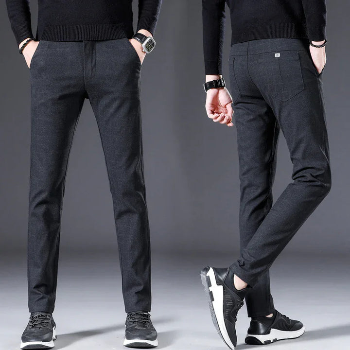 Men's black slim fit trousers paired with black sneakers and black knit sweater, front and back view