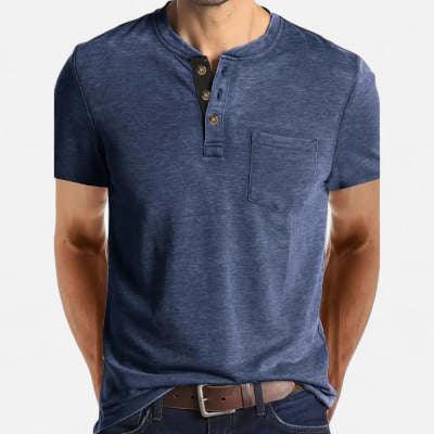 Man wearing blue short-sleeve henley shirt with front pocket and brown belt against white background