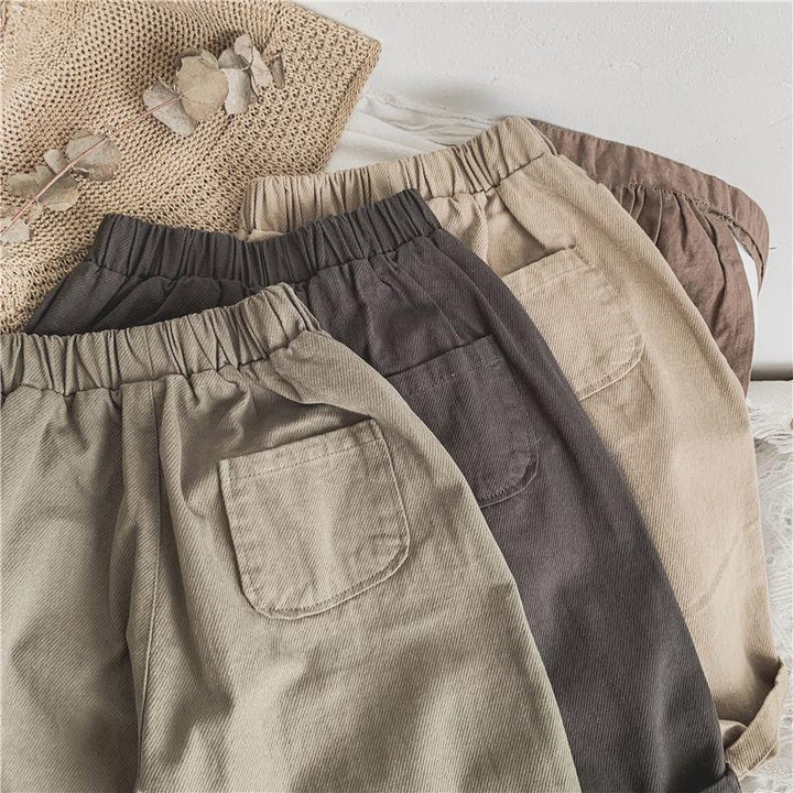 Three pairs of corduroy pants in beige, brown, and taupe with elastic waistbands and back pockets