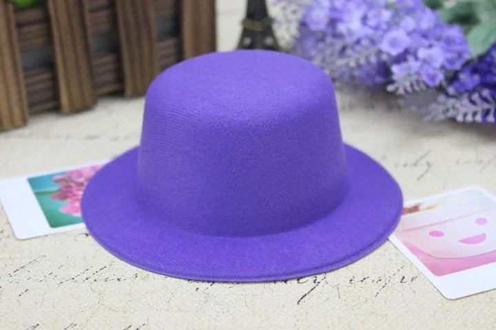 Purple felt bowler hat on a beige surface with blurred flowers and photos in the background