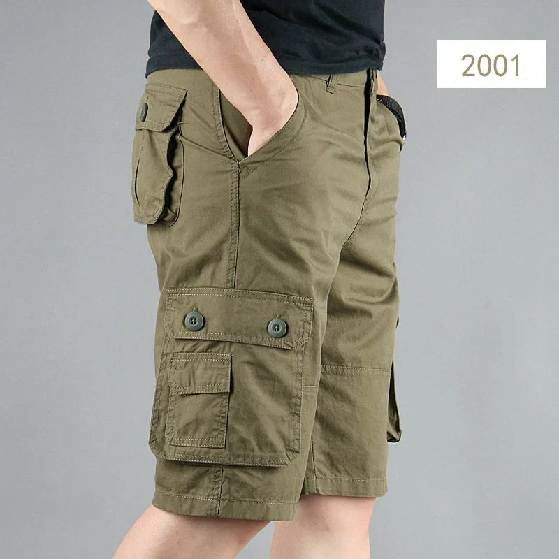 Side view of a man wearing olive green cargo shorts with multiple pockets and a black t-shirt