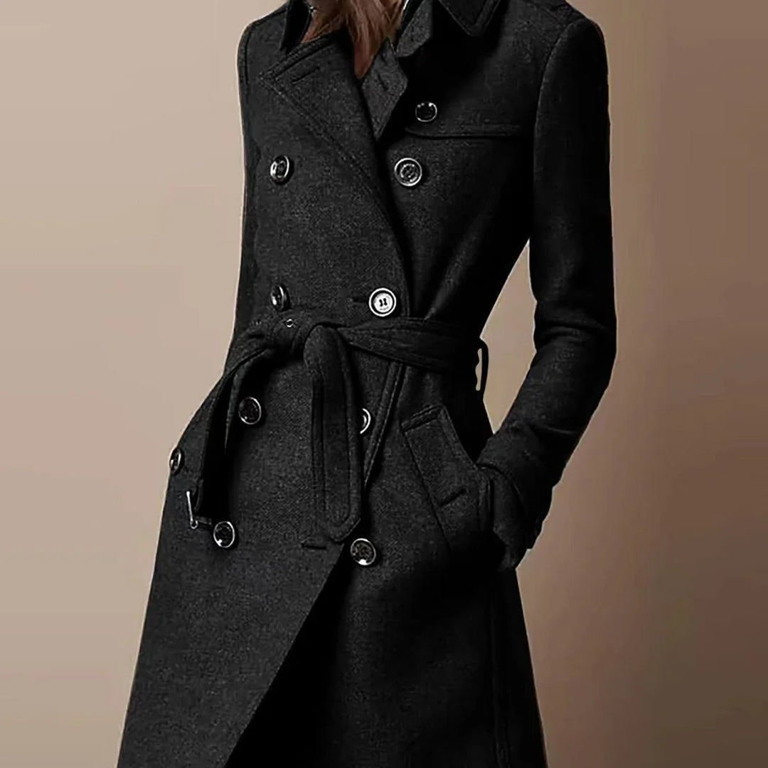 Close-up of a woman wearing a stylish black double-breasted wool coat with belt and pockets