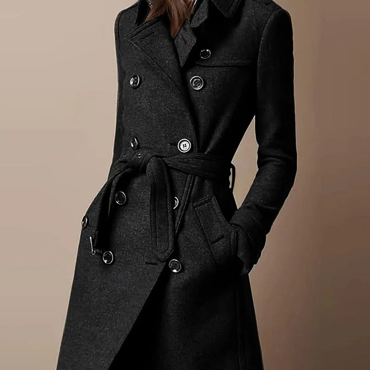 Close-up of a woman wearing a stylish black double-breasted wool coat with belt and pockets