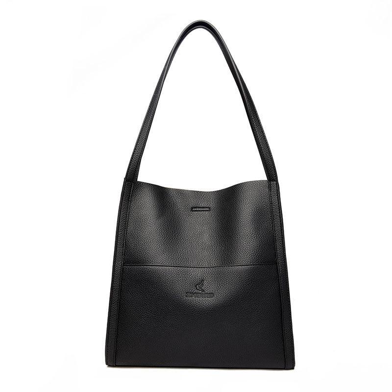 Black leather tote bag with long handles and minimal embossed logo on front