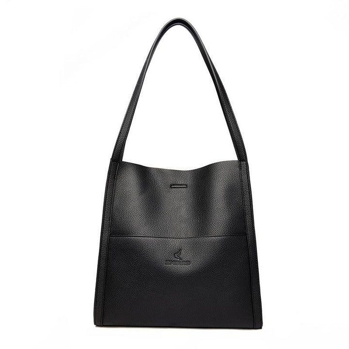 Black leather tote bag with long handles and minimal embossed logo on front