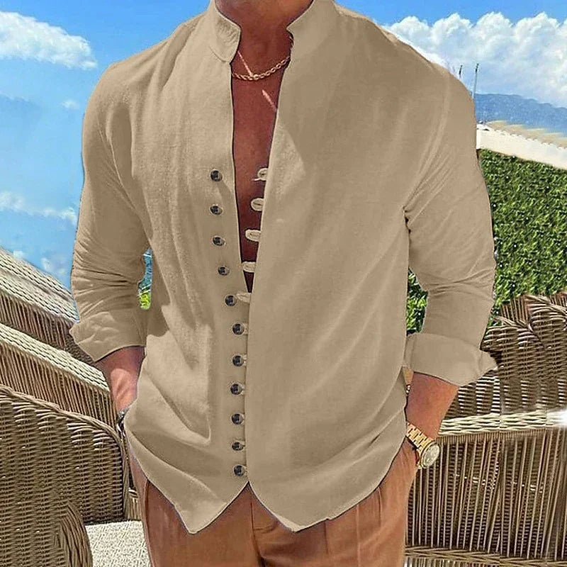 Man wearing beige casual linen shirt with unique button design, standing outdoors near wicker chairs