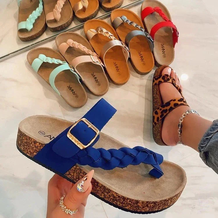 Collection of colorful braided strap cork sandals including blue, leopard print, red, gray, tan, pink, and mint green on marble floor