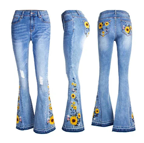 Light blue flared denim jeans with embroidered sunflower and floral designs, shown from front, side, and back