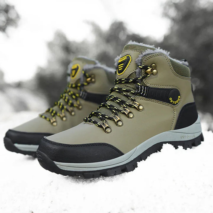 Olive green and black waterproof outdoor hiking boots with yellow accents on snow