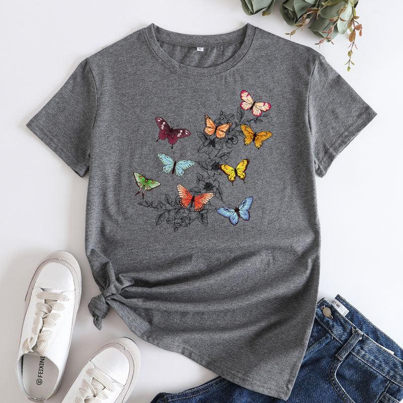 Gray t-shirt with colorful butterfly print paired with white sneakers and blue jeans on white background