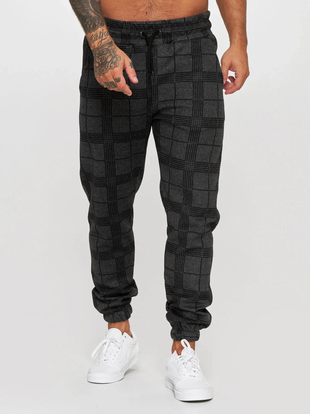 Men's black and dark gray plaid jogger pants with elastic cuffs and drawstring waist