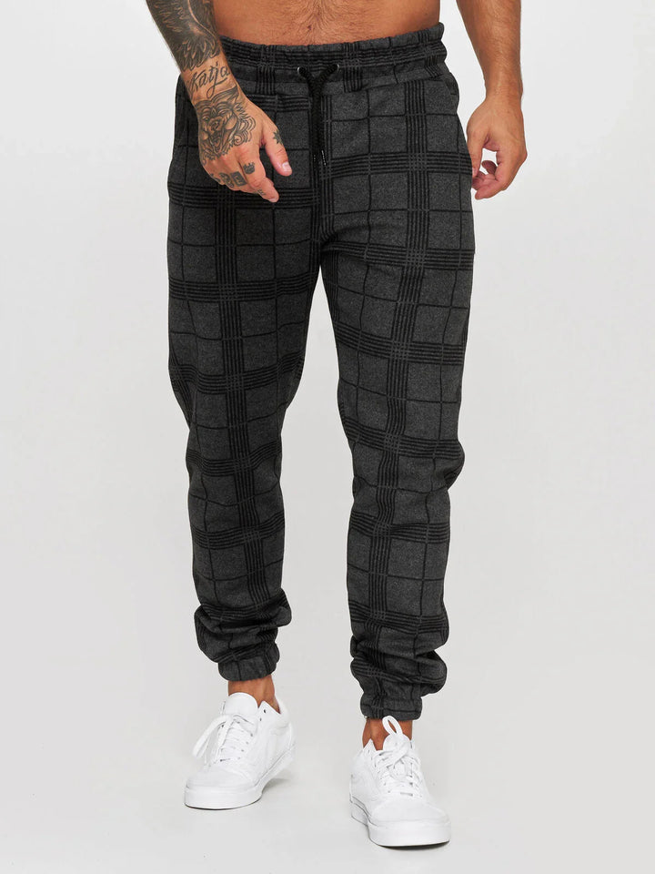 Men's black and dark gray plaid jogger pants with elastic cuffs and drawstring waist